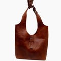 Handcrafted Moroccan leather bag purse in natural brown, featuring traditional stitching and a minimalist design, made from eco-friendly materials