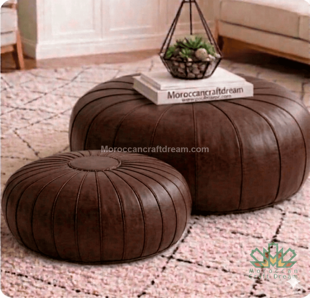 Two brown leather ottomans on a patterned rug with a small plant and book on top.